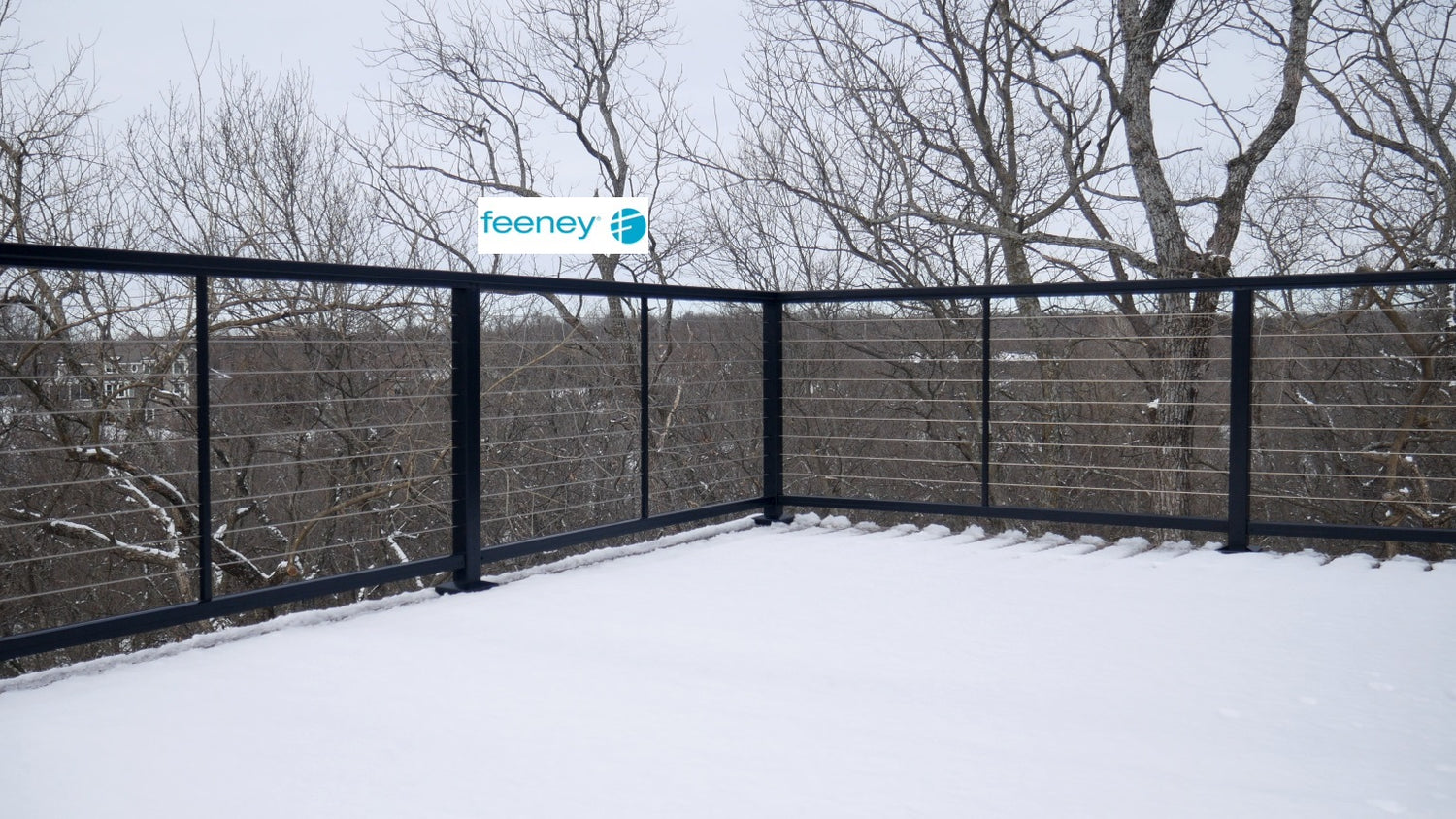 Feeney DesignRail Cable Railing corner on composite pvc deck holding in the snow