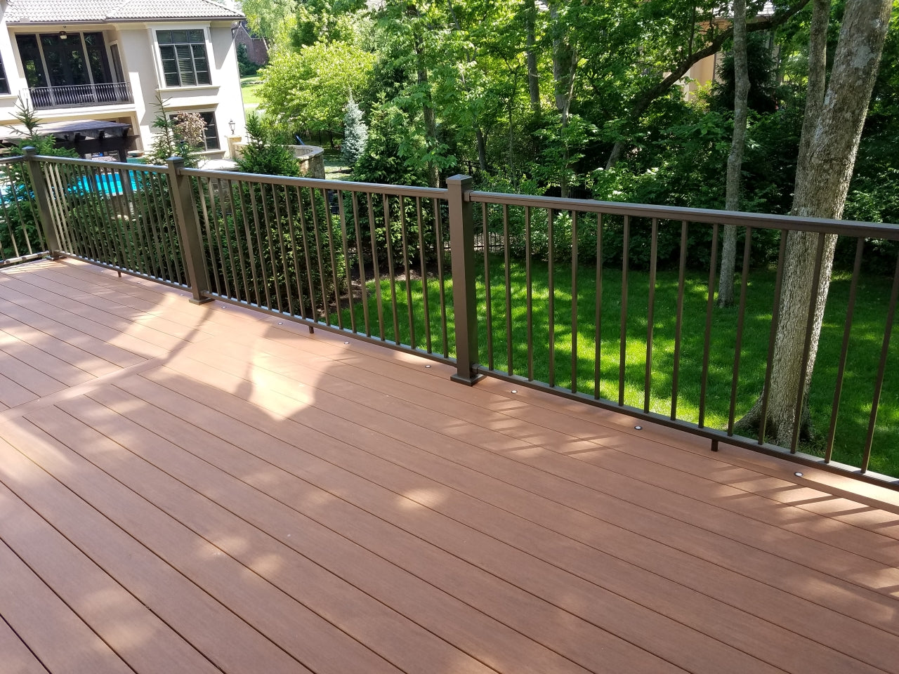 Azek Vintage Decking hidden fastened with cortex screws and plugs and original inpression rail with lighted deck dots. Impression rail is no longer an available railing option.
