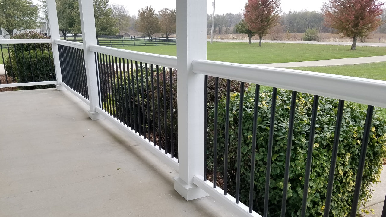 TimberTech Azek Premier Railing Composite Cap Rail with Aluminum Round Balusters Rail and posts are white and infill balusters are black
