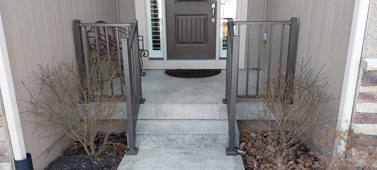 Front step guardrail aluminum railing westbury tuscany c10 in bronze texture level railing on the sides and stair railing down the concrete steps in the middle of stoop, the bronze railing matches the door and house color nicely