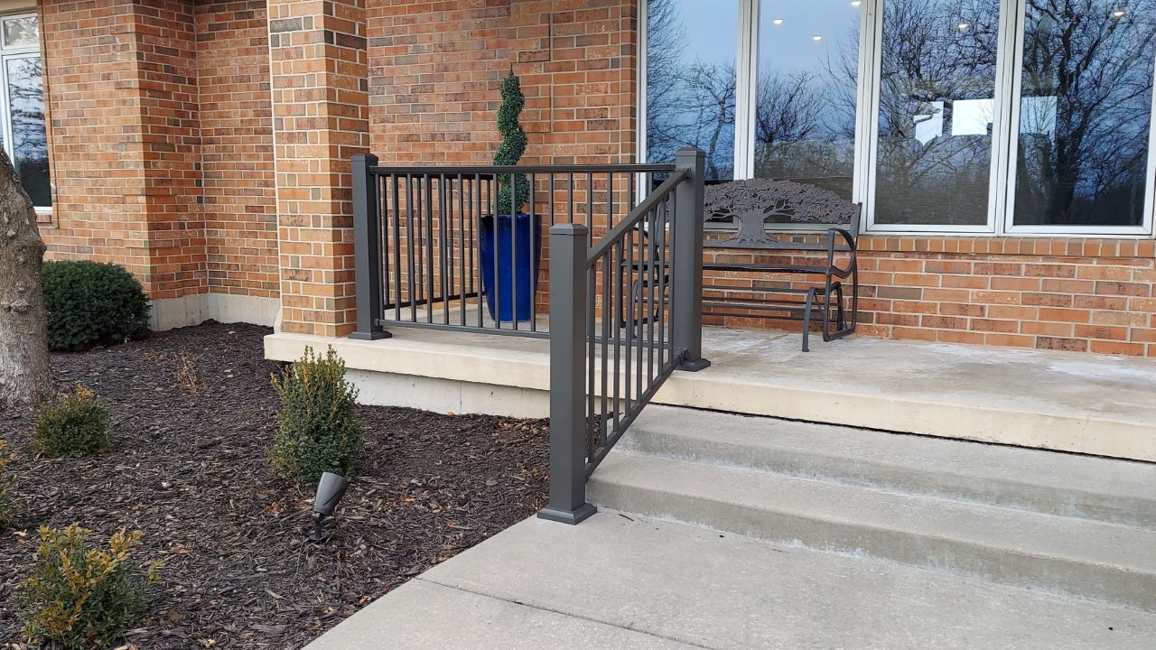 Porch Handrail or Porch Railing in Cocoa Bronze by DekPro is functional and looks great against a brick house on top of concrete. Aluminum porch railing is beautiful and easy to maintain. it will be a piece of the house from then on.