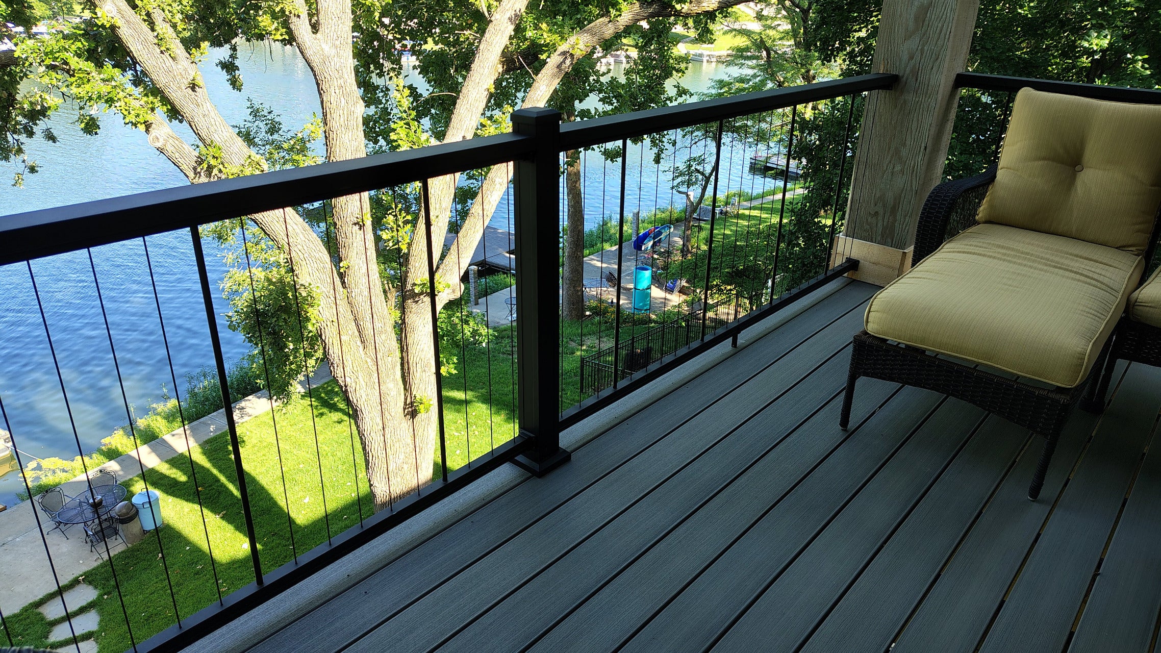 KeyLink Railing in Black with Chesapeake cap drink rail and vertical black cable overlooking a lake