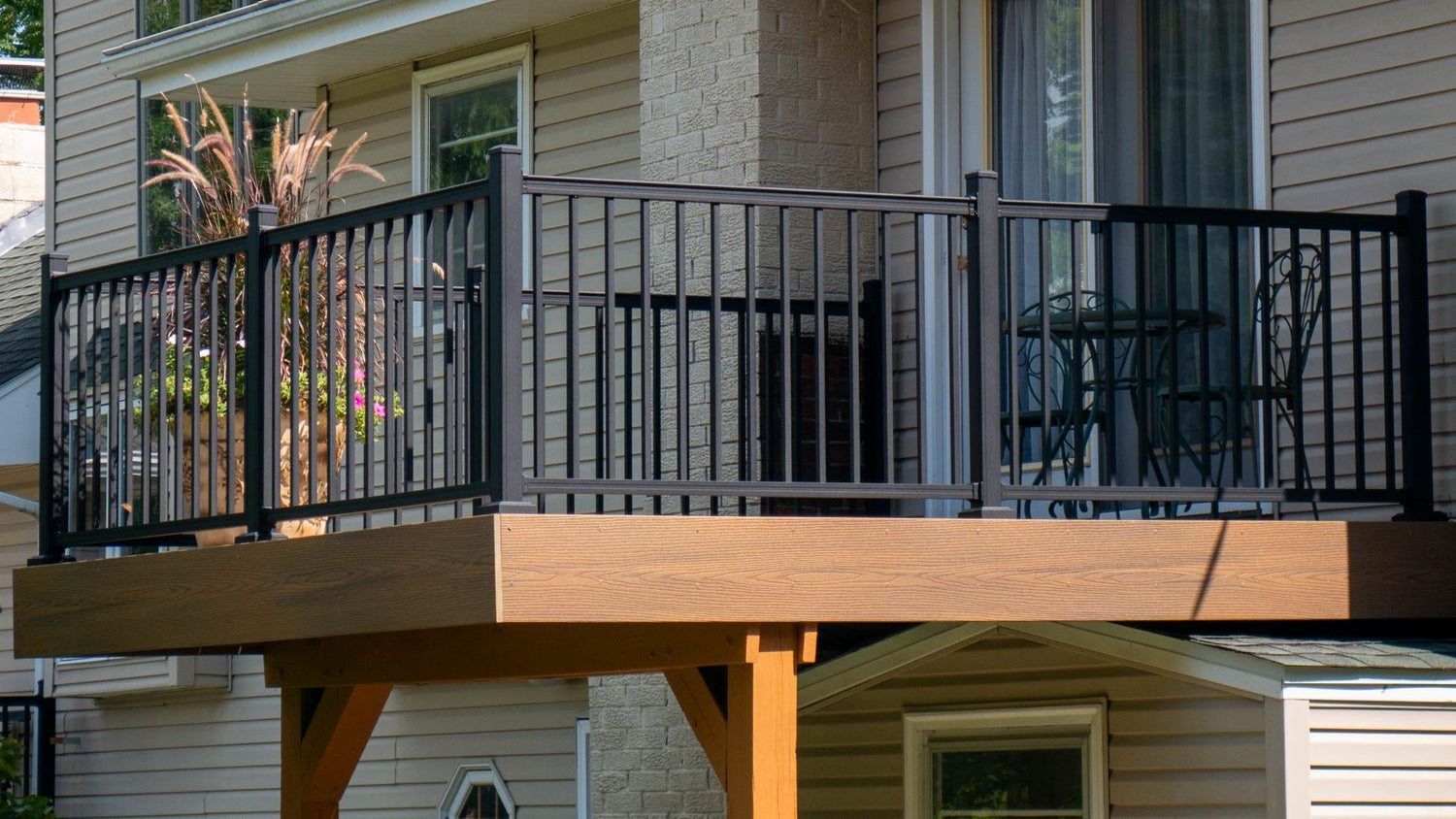 Aluminum deck railing on a walkout composite deck finishes the space nicely. Here we see advantage rail in textured black