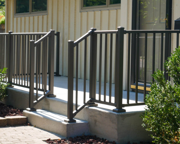 Wesbury Bronze concrete porch rail on concrete cement step for a safe outdoor patio lounging area uses aluminum porch rail with minimal two inch posts