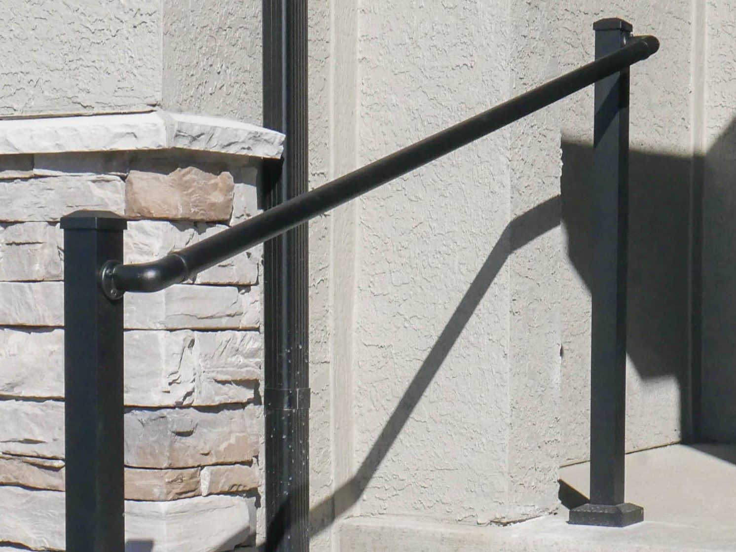 Black CHR between two posts and up a set of stairs