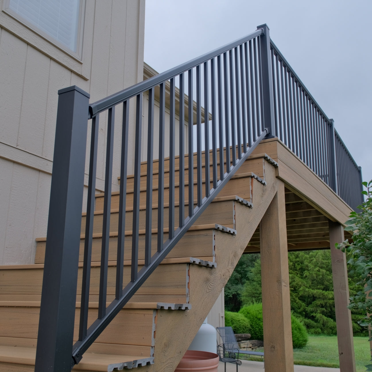 Dekpro Prestige aluminum stair handrail kit installed on a composite deck.
