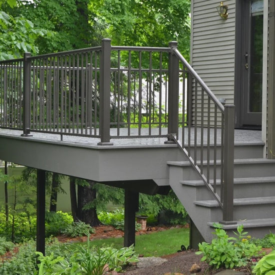 Outlook aluminum railing on back gray deck with steps and handrail around the perimeter and outlook rail on stairs