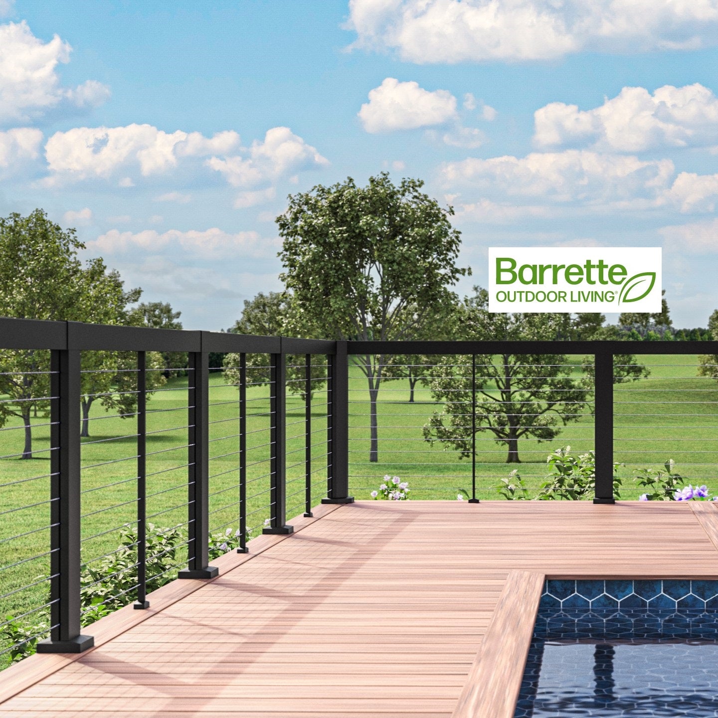 Barrette Elevation horizontal cable railing system black posts rails and pickets with seethrough cable on a pool deck under blue cloudy skys and green landscape