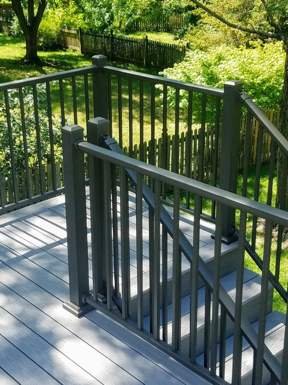 DekPro exterior deck railing kits and posts on composite deck classic landing and stair case at the end of the deck toward the yard, all aluminum dekpro is great for back decks either partially shaded or without shade