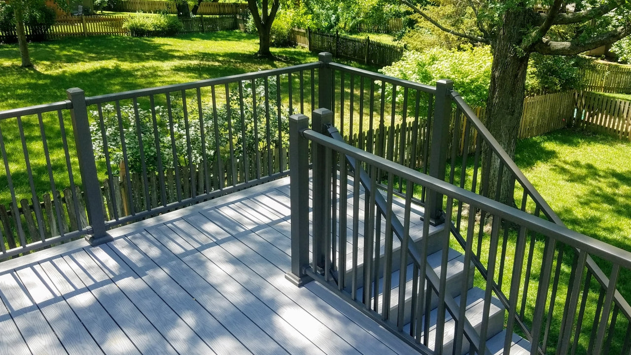 DekPro exterior deck railing kits and posts on composite deck classic landing and stair case at the end of the deck toward the yard, all aluminum dekpro is great for back decks either partially shaded or without shade