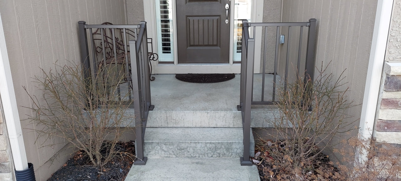 Front step guardrail aluminum railing westbury tuscany c10 in bronze texture level railing on the sides and stair railing down the concrete steps in the middle of stoop, the bronze railing matches the door and house color nicely 