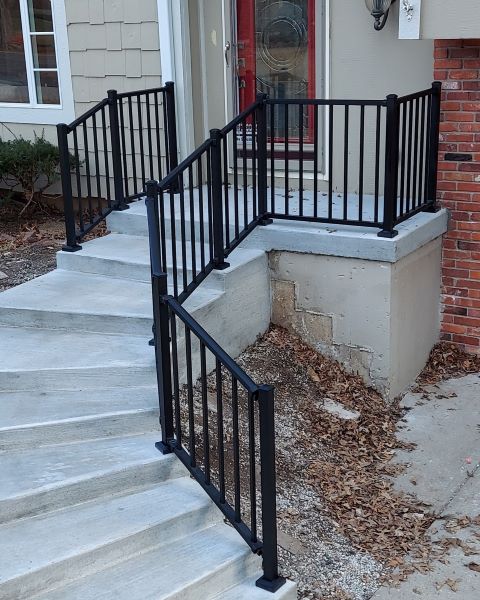 Tuscany C10 Landing and Stair Railing by Westbury, C10 Tuscany in Black Fine Texture guarding the steps to keep from falling off on the inside of the stair curve. Curved stairs are tricky to install railing on but westbury double swivel mounts