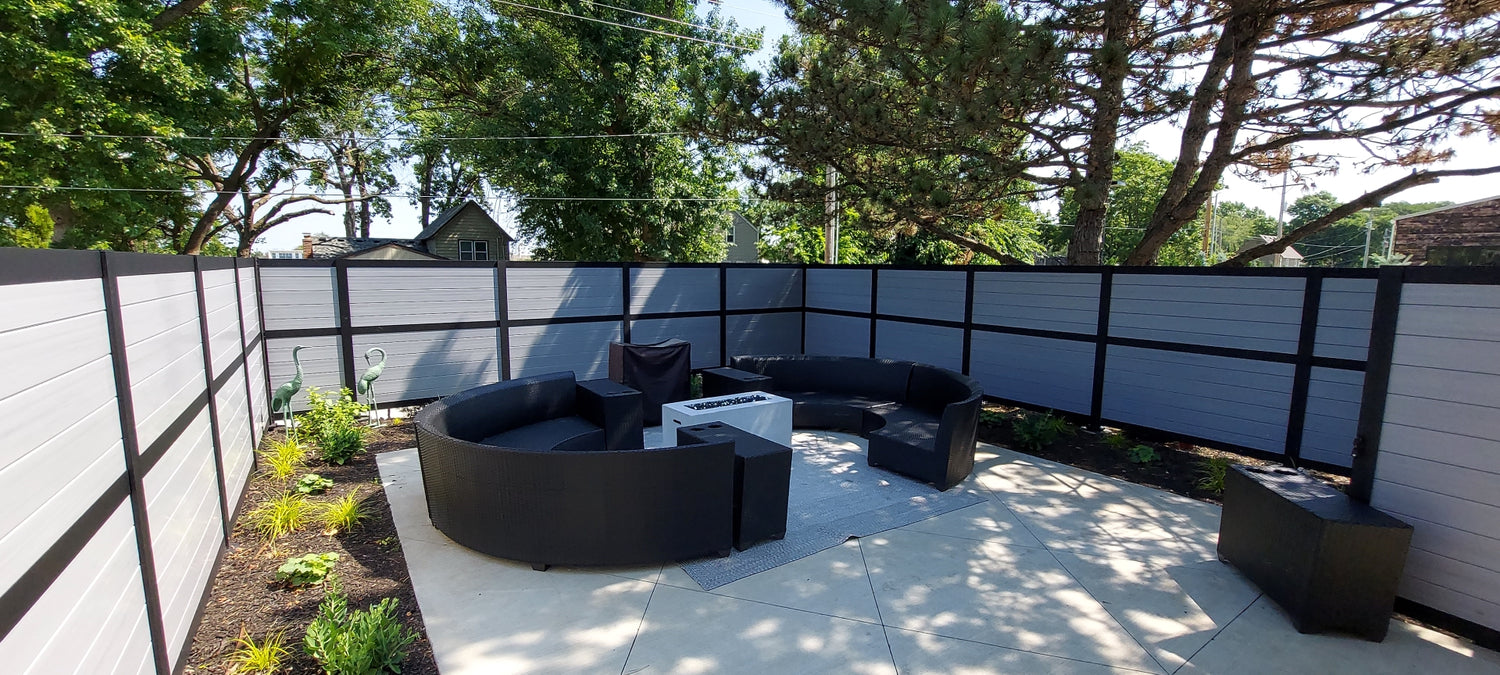 Enclosed privacy outdoor relaxing area had black posts and driftwood vinyl privacy infill