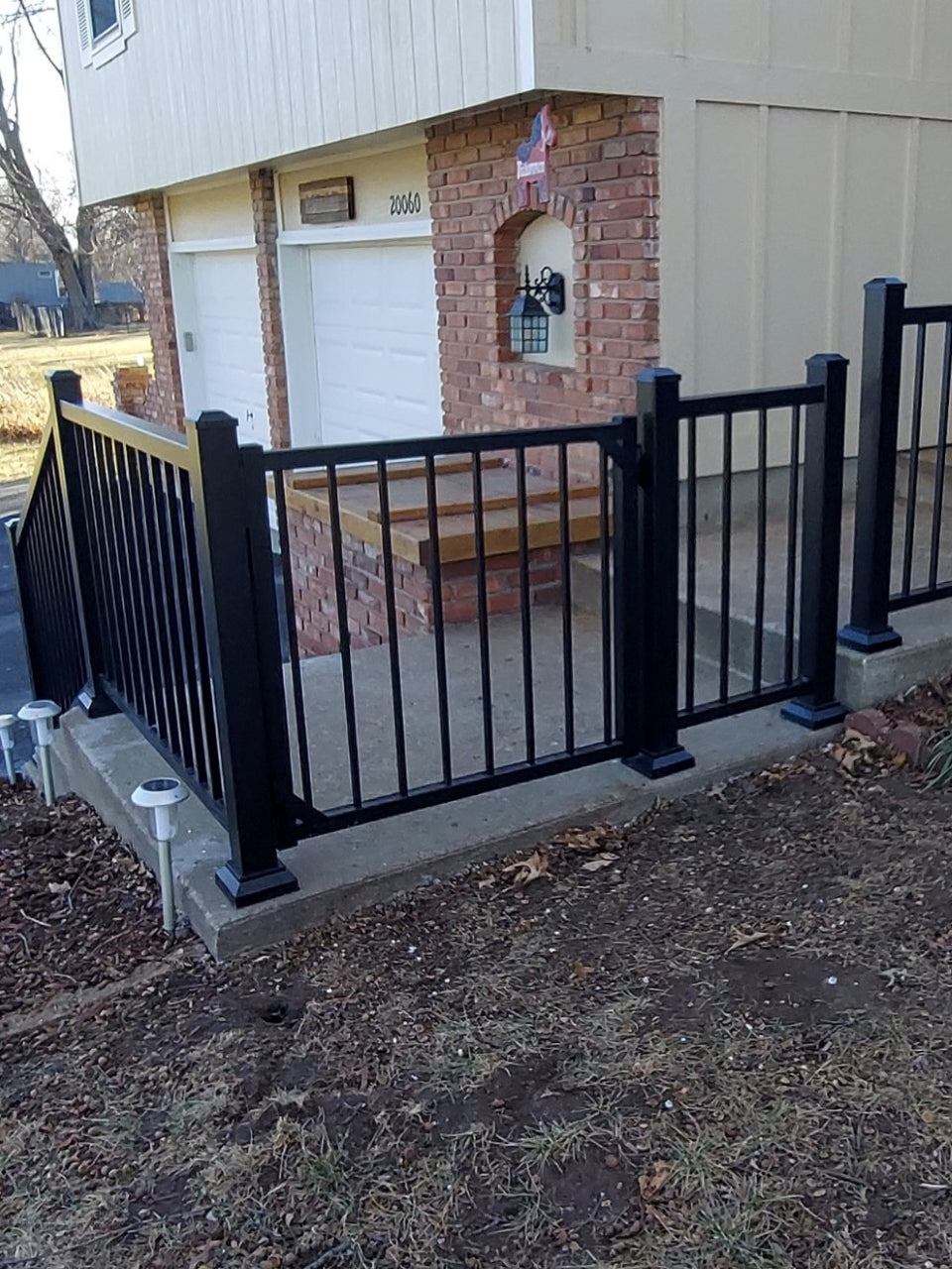 Front sidewalk with strong aluminum handrail barrier that contours the walkway and makes it easy to walk