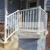 White Westbury Tuscany C10 Railing - stairs are seen on the left side of the photo with a taller post at the base of the steps, and level railing can be seen on the right side in an l-shape 