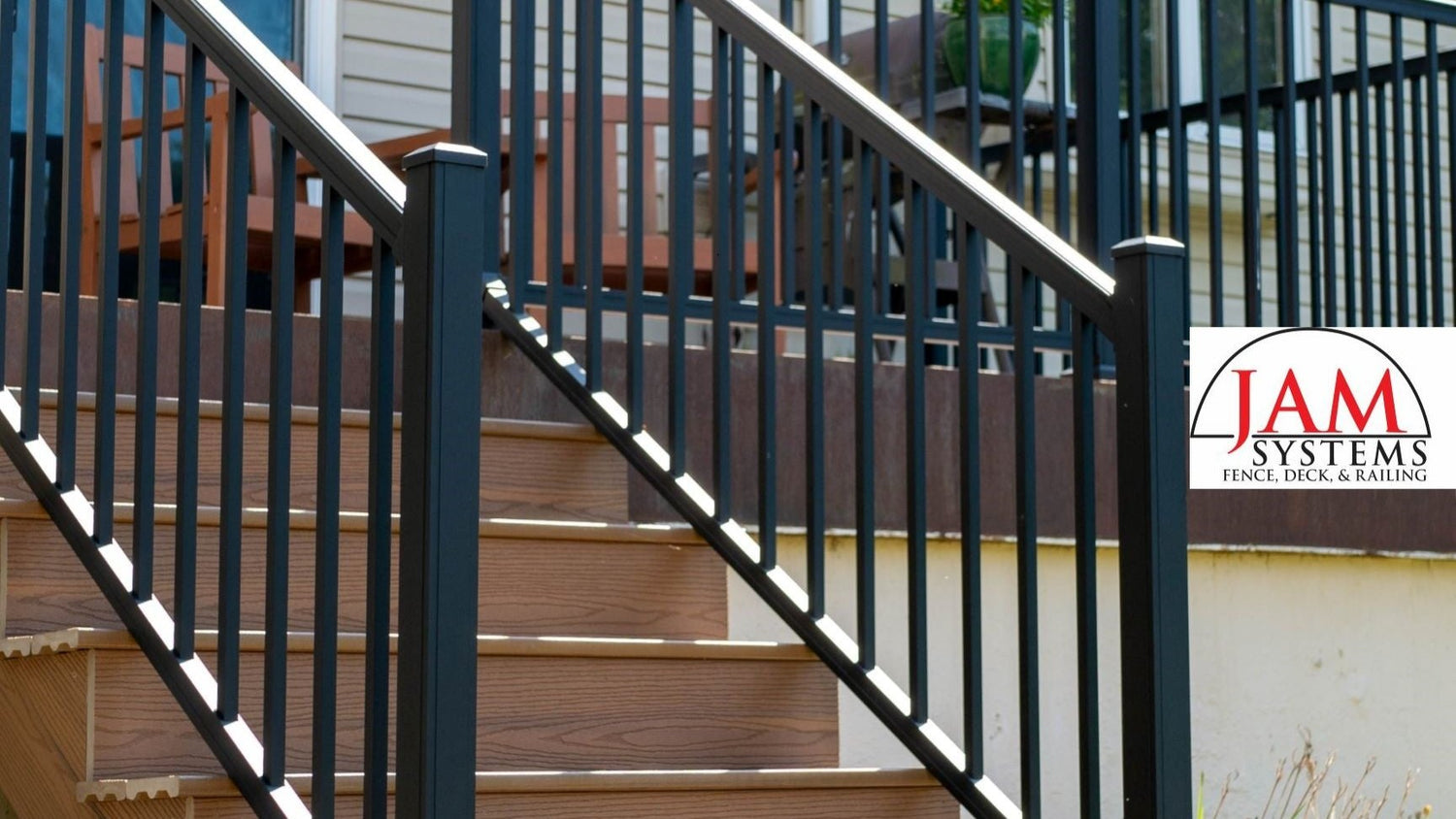 Advantage Deck Raling on a composite deck picturing railing on the stairs and advantage railing above, all in textured black with 2.5" posts