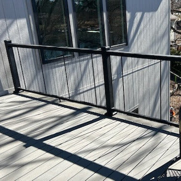 Black Cable Wire Railing with drainkrailing by KeyLink out the balcony on a wooden deck.