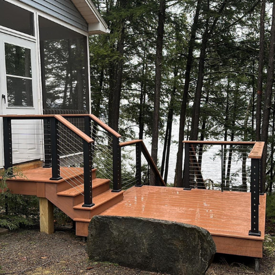 KeyLink Chesapeake Railing with Matching cap rail and decking, has black posts and rails with stainless horizontal cables.