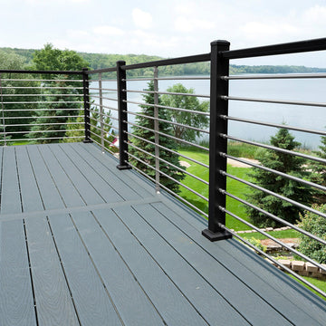 Deck with metal railing overlooking a scenic view of trees and water Anotized rod rail horizontal baluster picket railing