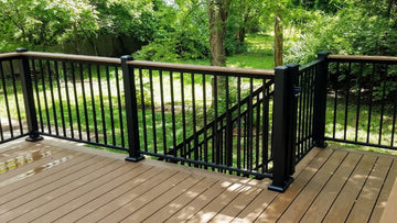 DekPro Prestige Black Textured Aluminum Railing with Drink Rail Cap Matching Deck Boards and a Gate Stair rail can be seen on the downside of the gate and is without drink rail to enable proper graspability