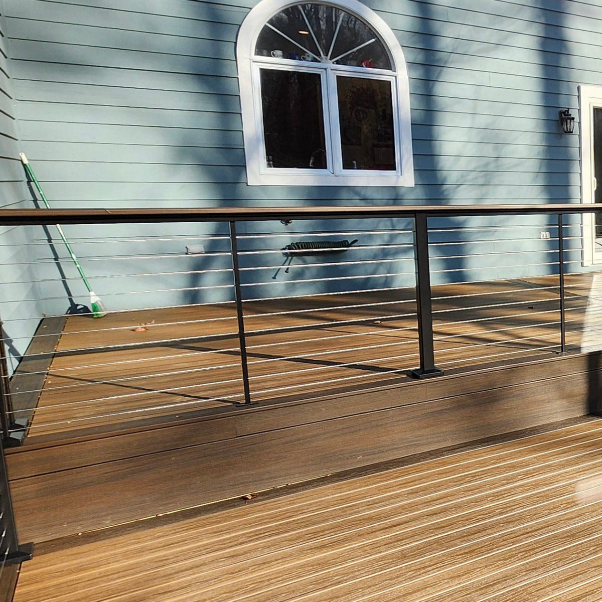 Feeney Modern Drink Rail shown with cap rail, Posts, and Cables sold separately. 