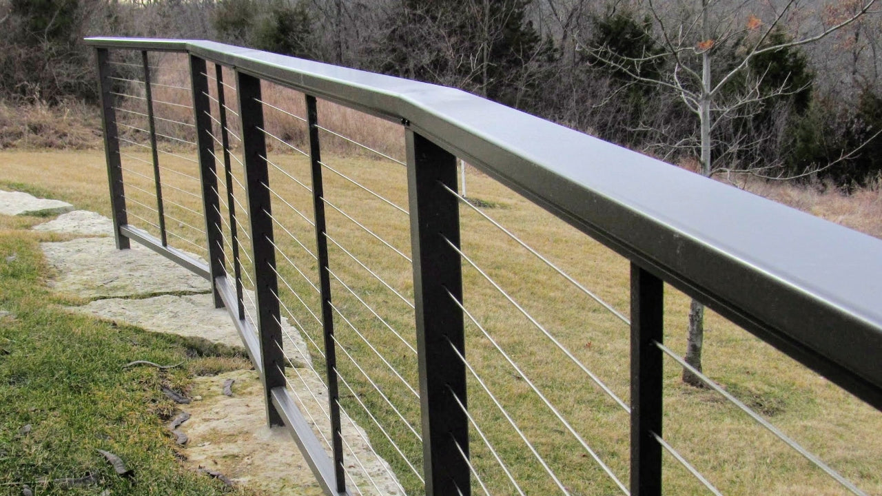 DesignRail aluminum and stainless steel horizontal cable with series 200 on curved bluff with posts core drilled into stone Deck & Rail Supply has been selling designrail like this for years! This railing was installed in 2014 in Overland Park, Kansas