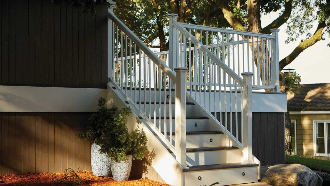 Impressions Rail Express by TimberTech Azek atop an pvc deck complete with lighting and pvc fascia. White aluminum impression express rail in level with transition to star railing looks stunning!