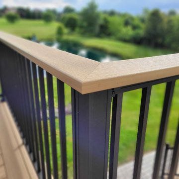 Chesapeake Black aluminum picket railing with decking top on a deck overlooking a green landscape