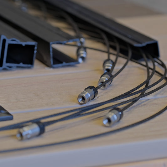 Close-up of black wire vertical cable rail kits with rails and connectors 