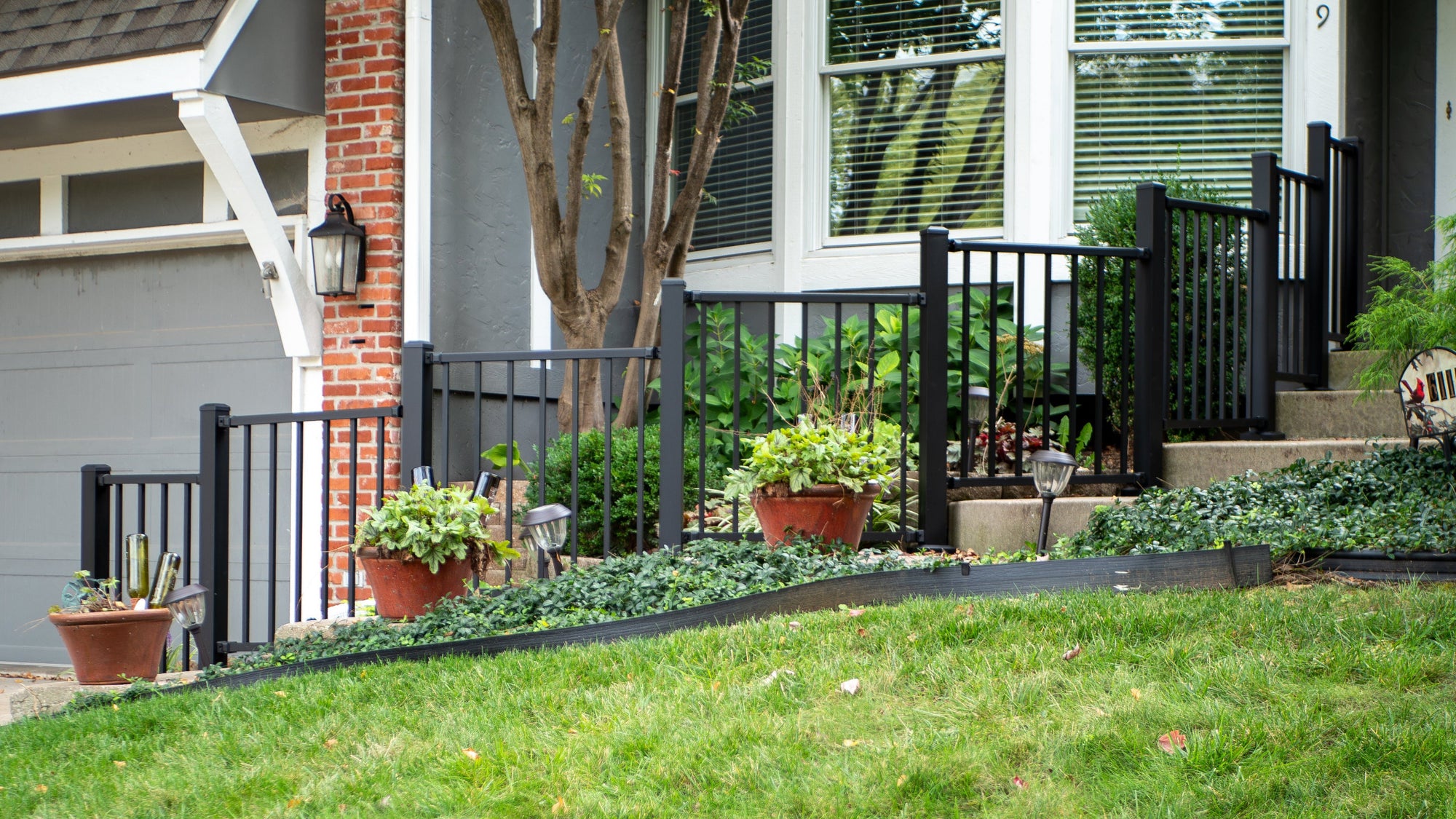 Westbury Tuscany Level Railing, stepping up each wide step and radiused with a swivel bracket.