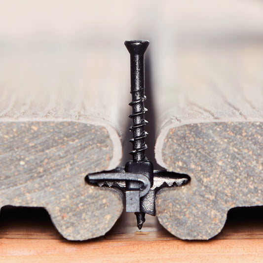 Ninja clip in action to be installed between two deck boards, displaying how hidden fasteners clips sit in decking grooves. 
