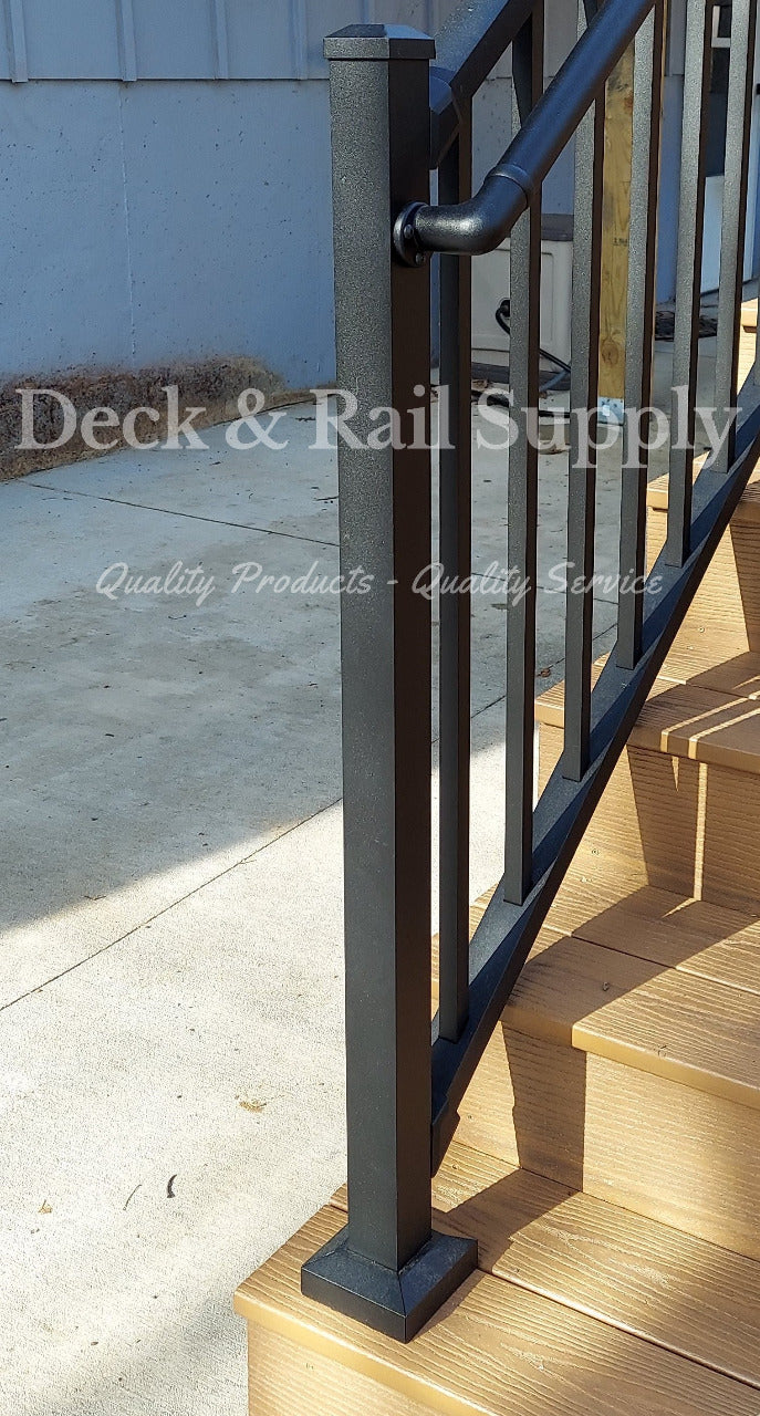 47 inch black texture stair post on composite deck stair tread at the bottom of the stair way with handrail attached  to side, not included are handrails and railing.